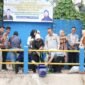 Rektor Unila, Prof Lusmeilia Afriani, ikut menebar ratusan kilogram benih ikan di kawasan Embung D. (foto: ist)